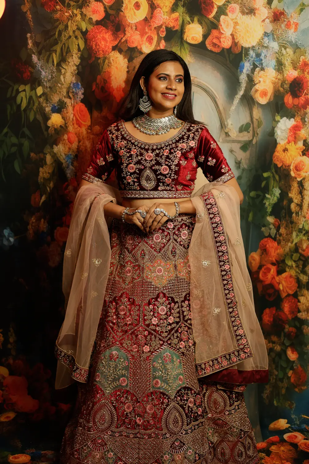 Embroidered bridal lehenga in chiffon fabric with matching potli bag accessory.